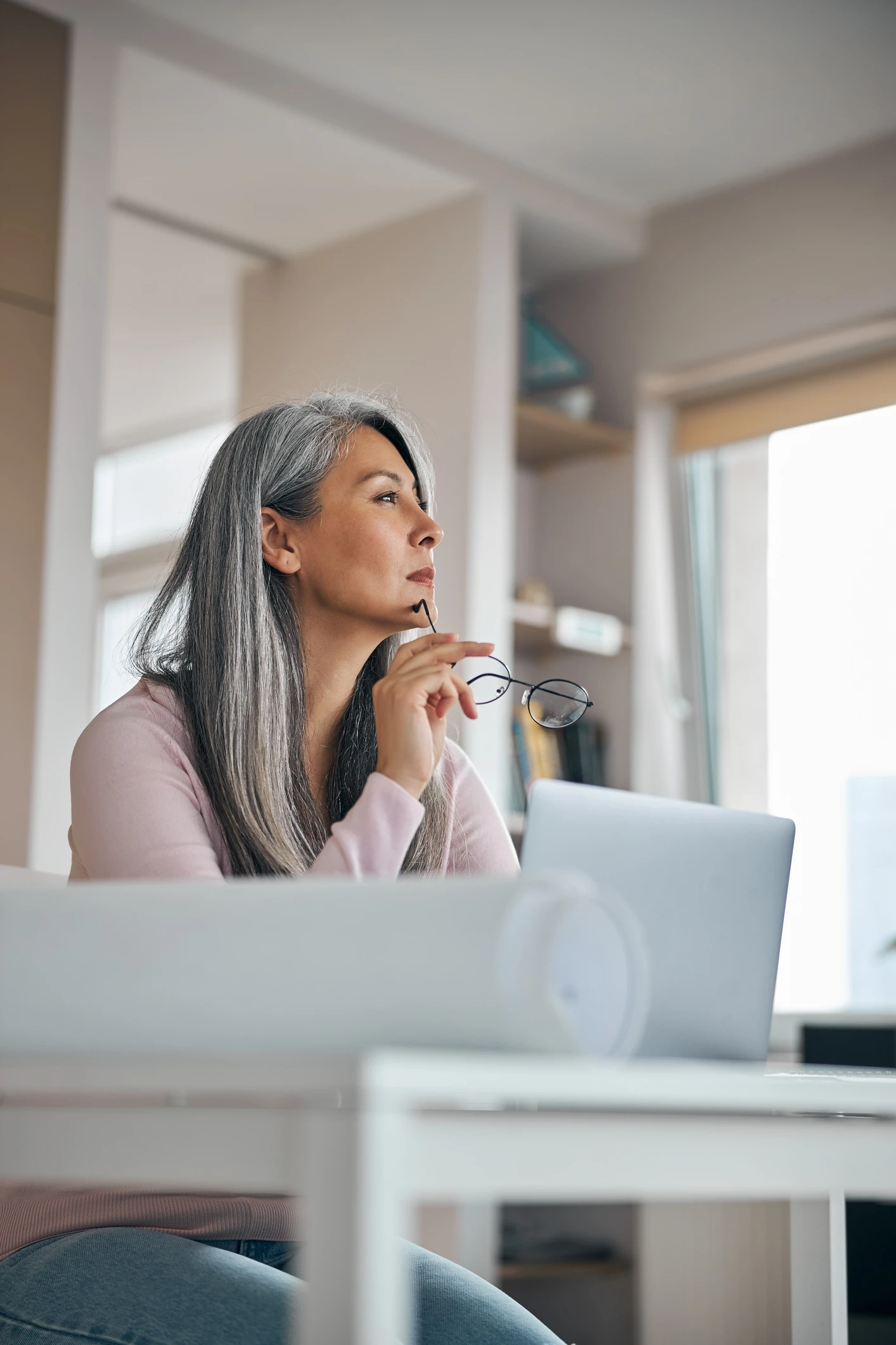 Charming woman working on project and using notebook at home